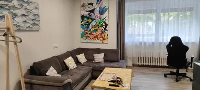 a woman sitting in a chair in a living room at Minihotel Vitex in Prague