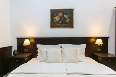a bedroom with a bed with a painting on the wall at Apartrezidence Opletalova in Prague