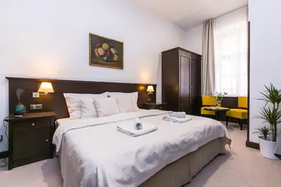 a bedroom with a large bed with two trays on it at Apartrezidence Opletalova in Prague