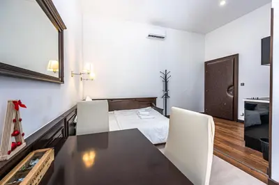 a room with a table and chairs and a bed at Apartrezidence Opletalova in Prague