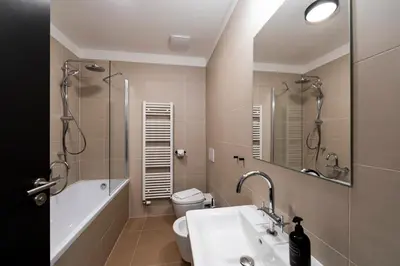 a bathroom with a sink and a shower and a toilet at Miss Sophie's Downtown in Prague
