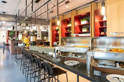 a restaurant with a long counter with a lot of food at Miss Sophie's Downtown in Prague