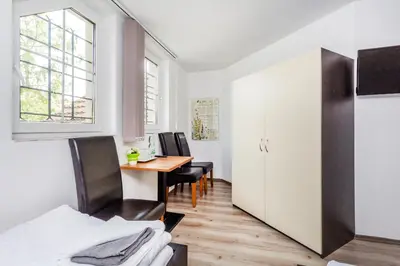 a room with a table and chairs and a desk at Nová Hospoda - Hotel & Restaurant in Prague