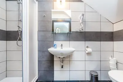 a bathroom with a sink and a mirror at Nová Hospoda - Hotel & Restaurant in Prague