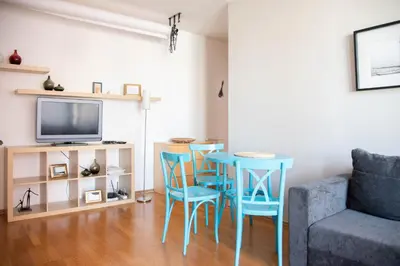 a living room with a table and chairs and a tv at Apartment Tereza in Prague