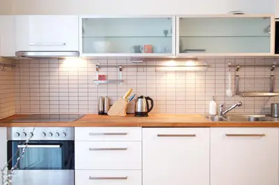 a kitchen with white cabinets and a sink at Apartment Tereza in Prague