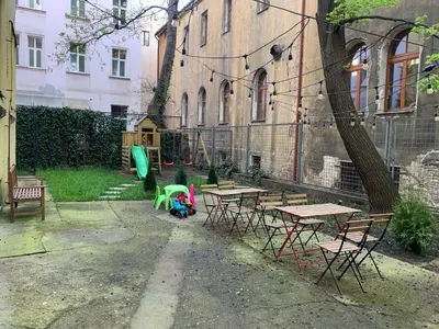 a playground with picnic tables and a green slide at Downtown Residence in Prague