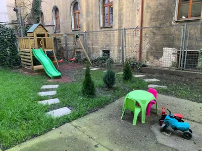 a backyard with a playground with a slide and a table at Downtown Residence in Prague