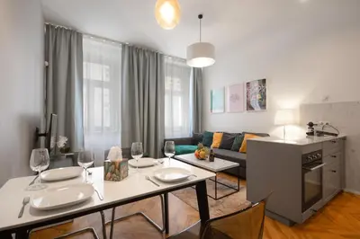 a living room with a table with wine glasses at Downtown Residence in Prague