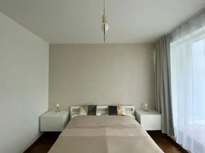 a bedroom with a large bed and two tables at New residence apartments near Wenceslas Square in Prague