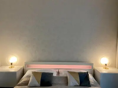 a bedroom with a bed with two lamps on both sides at New residence apartments near Wenceslas Square in Prague