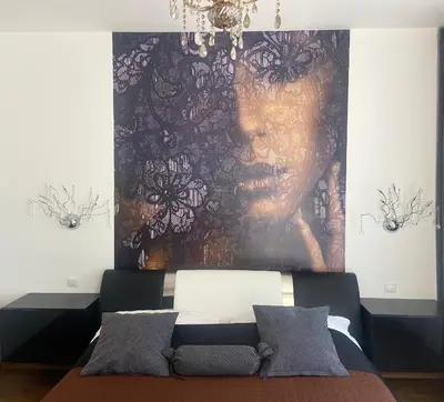 a bedroom with a large painting on the wall at New residence apartments near Wenceslas Square in Prague