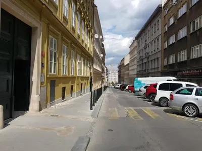 a city street with cars parked next to buildings at New residence apartments near Wenceslas Square in Prague