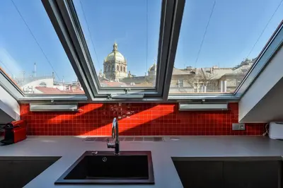 a kitchen with a sink and a view of a building at Designer Loft in Prague