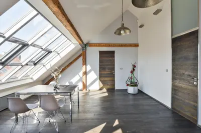 an attic dining room with a table and chairs at Designer Loft in Prague