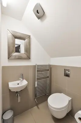 a bathroom with a toilet and a sink and a mirror at Designer Loft in Prague