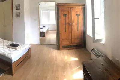 a room with a bed and a wooden cabinet at Adela´s Czech Village House in Všejany