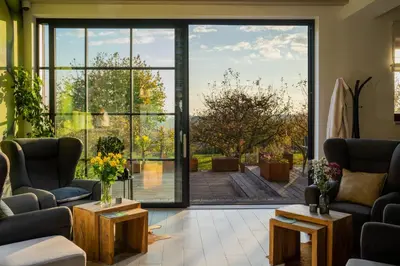 a living room with a large glass door leading to a patio at Hotel Grunt in Mladá Boleslav