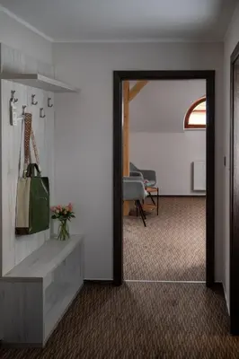 a hallway with a door leading to a living room at Hotel Grunt in Mladá Boleslav