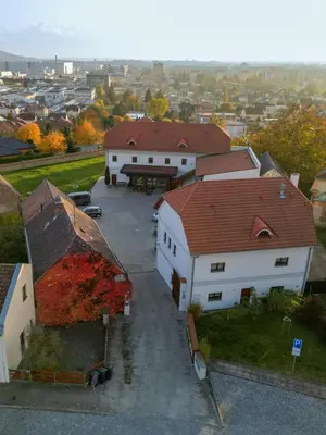 an aerial view of a white house with a red roof at Hotel Grunt in Mladá Boleslav