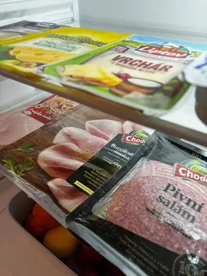 a refrigerator filled with meat and other food items at HOTEL DIANA apartments in Prague