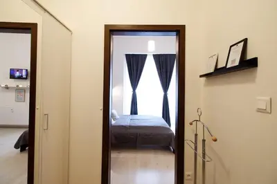 a bedroom with a bed and a door with a window at Snajder Apartment, 15min to Old Centre, Self-check in, Free Wifi in Prague