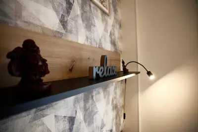 a shelf on a wall with a sign on it at Snajder Apartment, 15min to Old Centre, Self-check in, Free Wifi in Prague