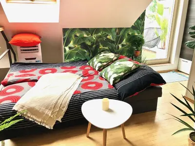 a living room with a couch and a table at Duplex with quite terrace on Wenceslas sq. in Prague