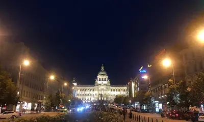 a large building at night with a street in front at Duplex with quite terrace on Wenceslas sq. in Prague