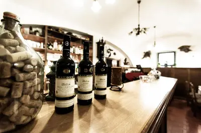 three bottles of wine sitting on a bar at Pension U Dvou čápů in Chocerady