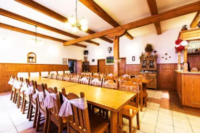a large dining room with a long table and chairs at Pension U Dvou čápů in Chocerady
