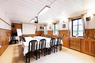 a large dining room with a table and chairs at Pension U Dvou čápů in Chocerady
