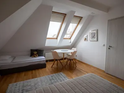 a living room with a table and a couch at Residence Sarka in Prague