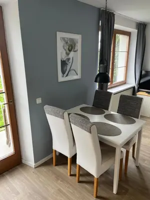a dining room with a white table and chairs at Residence Sarka in Prague
