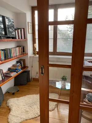 a room with a door and a table and books at Residence Sarka in Prague
