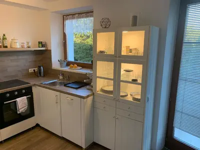 a kitchen with a cabinet with dishes in it at Residence Sarka in Prague