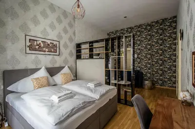 a bedroom with a large bed and a table at Design 3BDR Apartment in residence, FREE PARKING in Prague