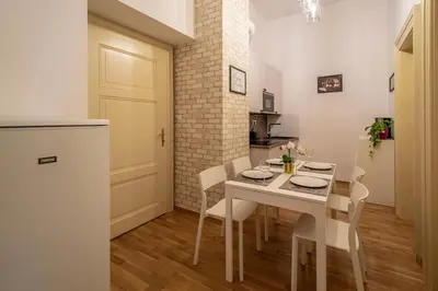a kitchen and dining room with a table and chairs at Design 3BDR Apartment in residence, FREE PARKING in Prague