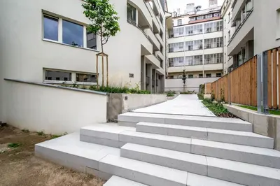 a set of concrete stairs in front of buildings at Design 3BDR Apartment in residence, FREE PARKING in Prague