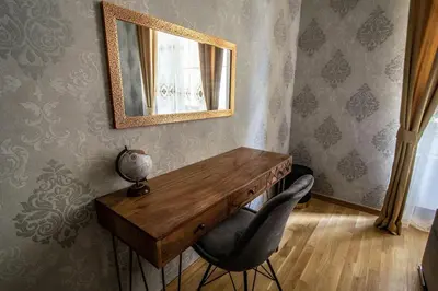 a room with a wooden table and a mirror at Design 3BDR Apartment in residence, FREE PARKING in Prague