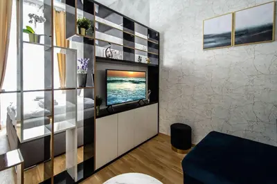 a living room with a tv on a wall at Design 3BDR Apartment in residence, FREE PARKING in Prague
