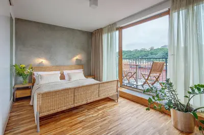 a bedroom with a bed and a balcony at Holečkova Apartments in Prague