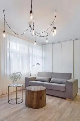 a dining room with a table and chairs and a balcony at Holečkova Apartments in Prague