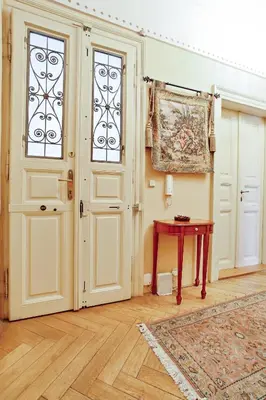 a room with a door and a table with a rug at Open Gate in Prague