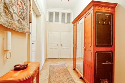 a hallway with a red cabinet and a mirror at Open Gate in Prague