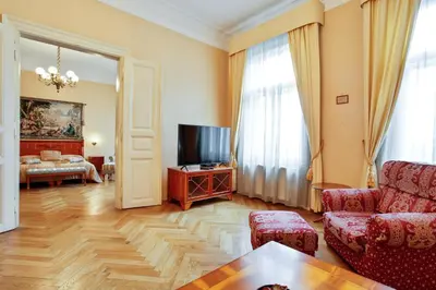 a living room with a couch and a tv at Open Gate in Prague