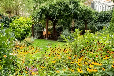 a garden with a gazebo and flowers at Open Gate in Prague