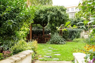 a garden with a gazebo in a yard at Open Gate in Prague