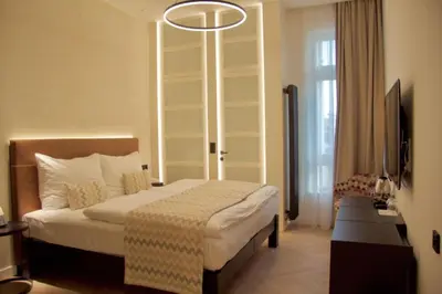 a hotel room with a bed and a sign that says parking till at Chevron Hotel in Prague