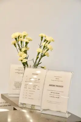 a vase with flowers sitting on top of two books at Chevron Hotel in Prague